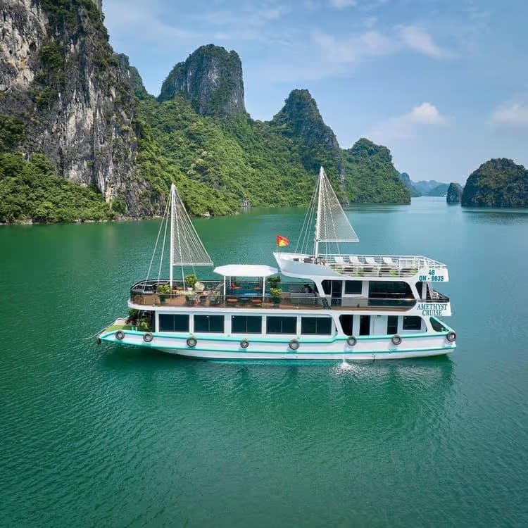 A night aboard a luxury cruise in Halong Bay, sailing between limestone cliffs